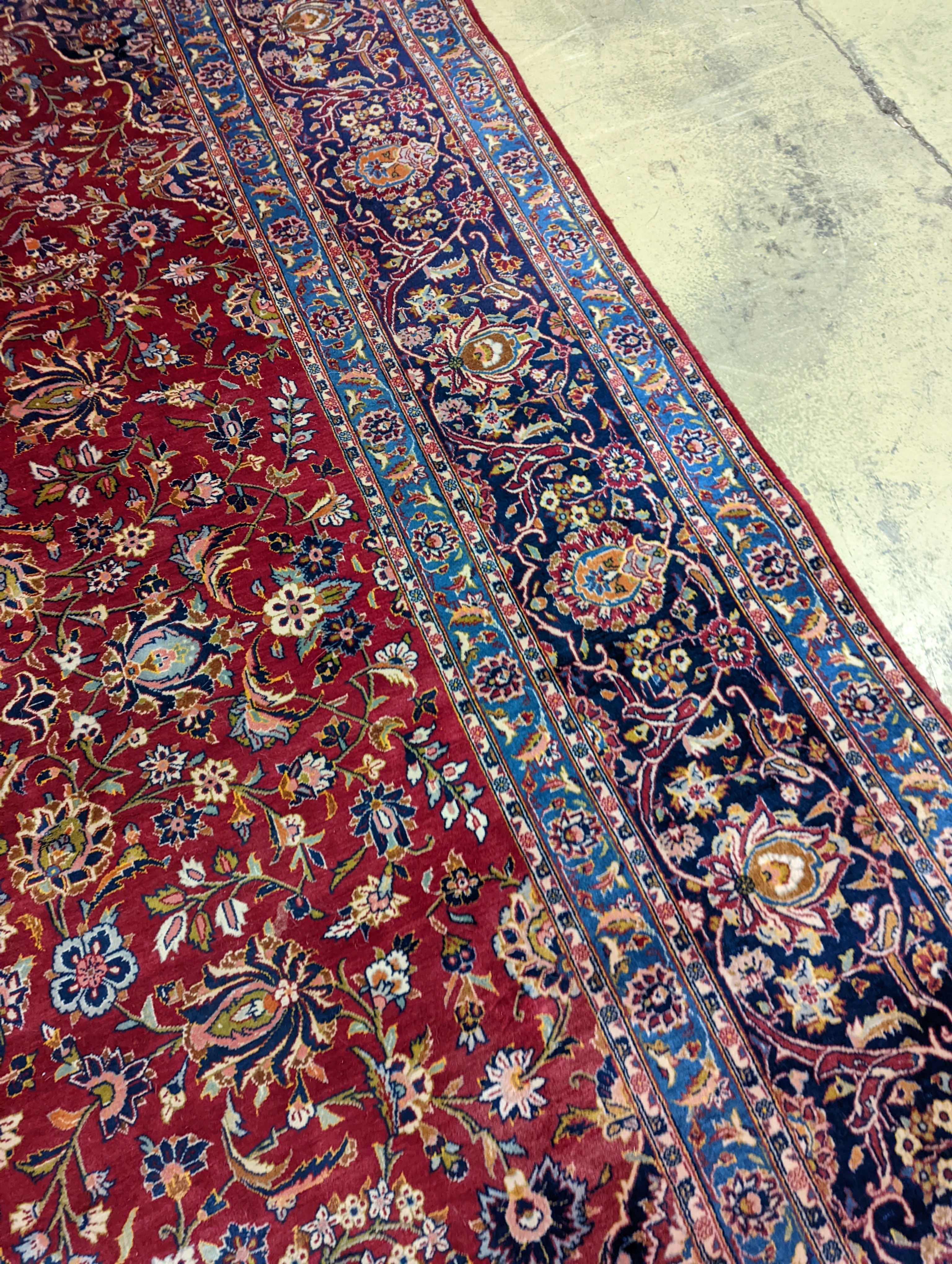 A large Tabriz red ground floral carpet, 540 x 350cm